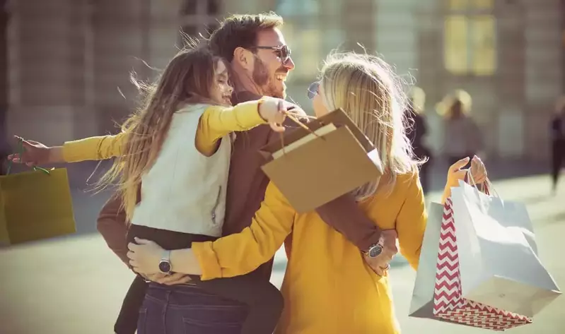 family carrying shopping bags