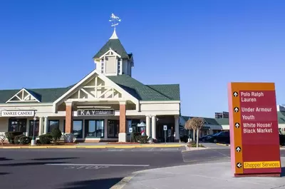 Tanger Outlets directional sign in front of shops