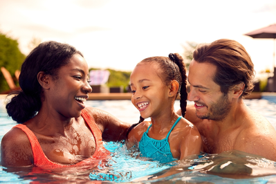 family in outdoor swimming pool